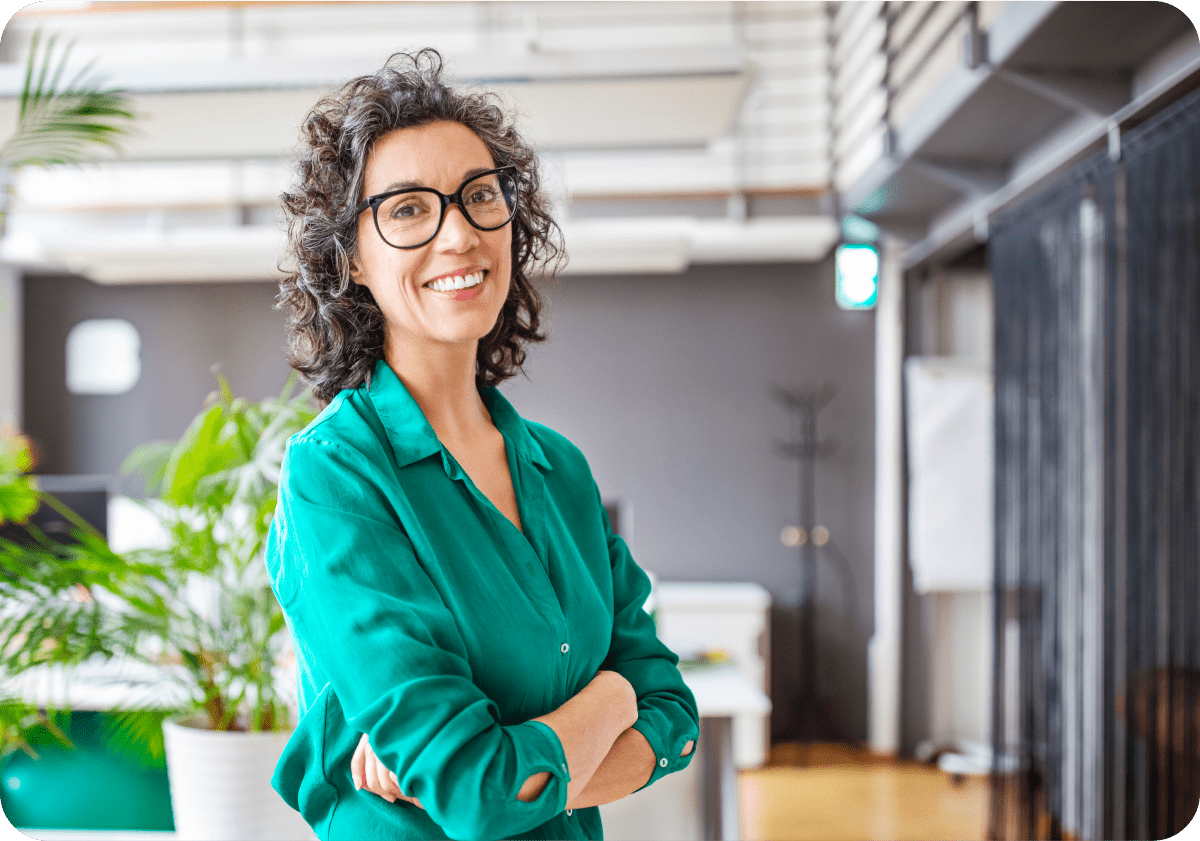 a woman in a green shirt and glasses